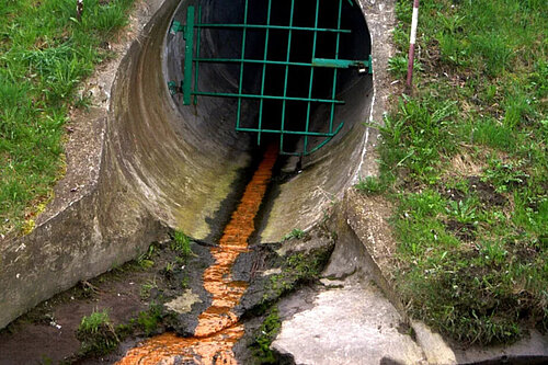 Sewage streaming out of a pipe