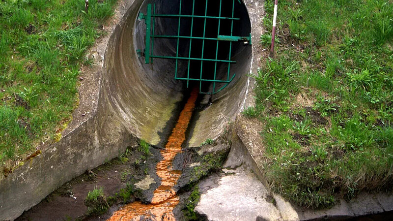 Sewage streaming out of a pipe